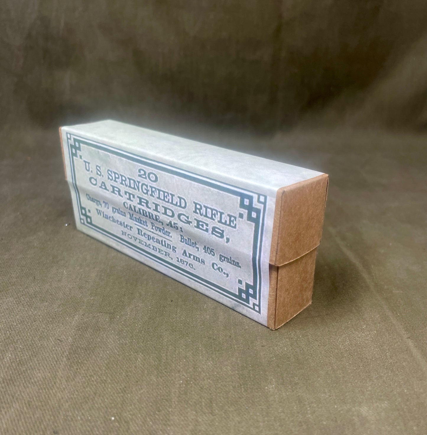 Box of U.S. Springfield Rifle Cartridges on a brown background