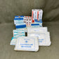 Collection of medical supplies including triangular bandages and other包扎材料 on a brown background