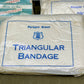 Packaged Paragon Brand triangular bandage on a textured surface