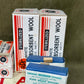 Boxes of sterilized white absorbent wool and Paragon plain wound dressing on a green background