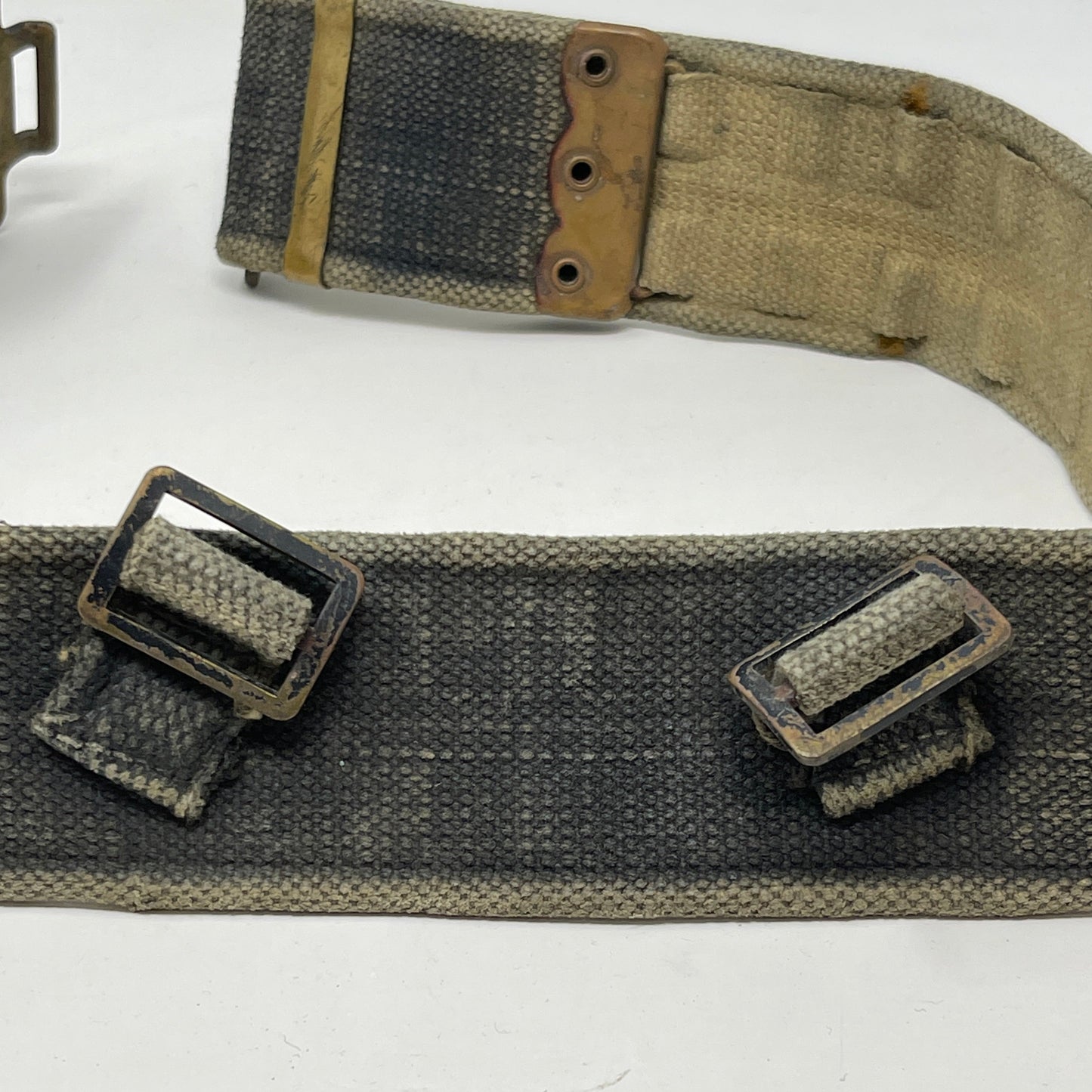 rear view of webbing belt showing brass buckles for shoulder straps